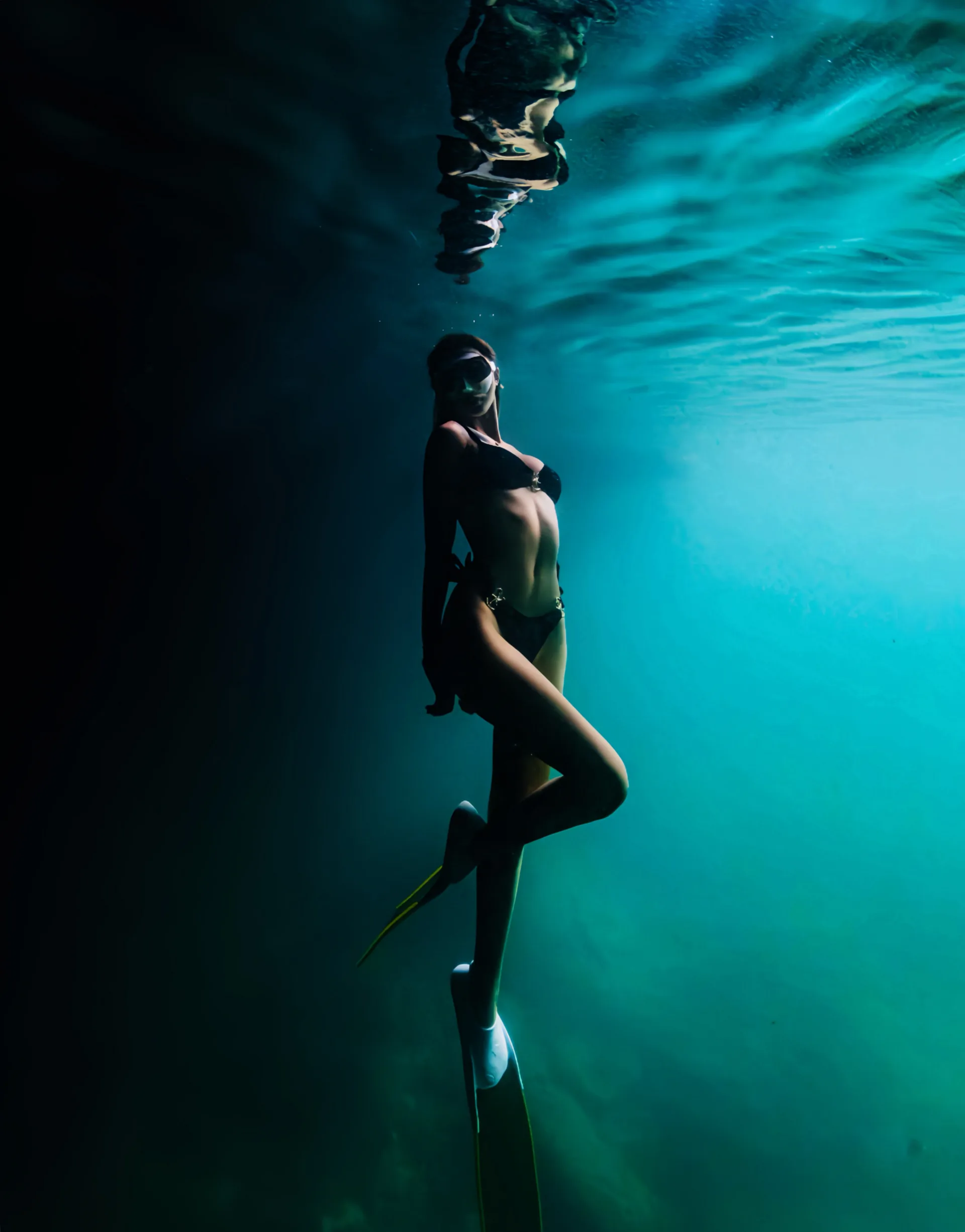A freediver descending on a single breath